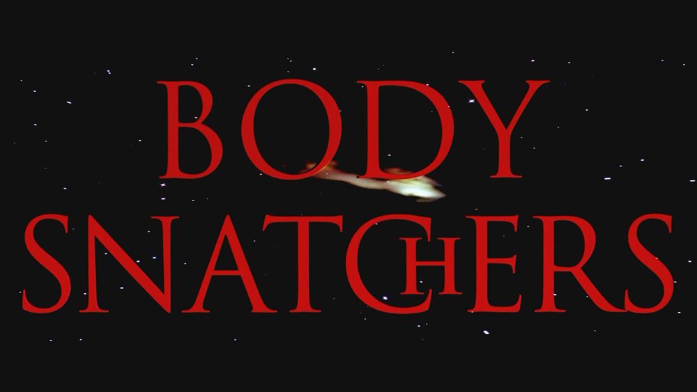 Screenshot of the movie The Body Snatchers featuring red text on dark sky with falling star.
