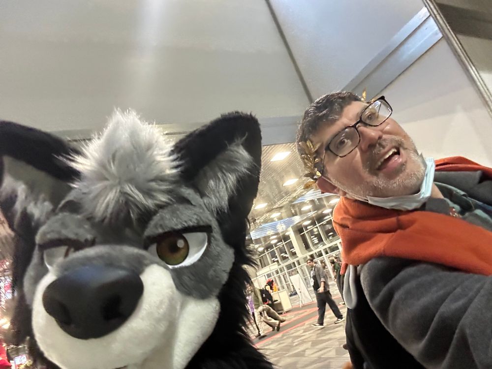Me and my husband (wearing his fursuit head) in walking to the pre-reg line for MFF