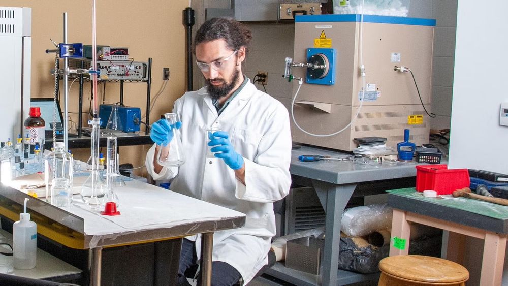 Keith Cleland (MASc ’22) working inside of a lab