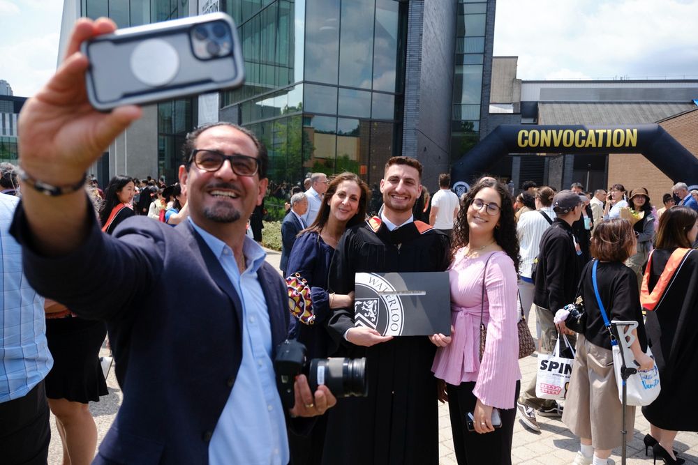 A dad taking a selfie with his family at the convocation celebration