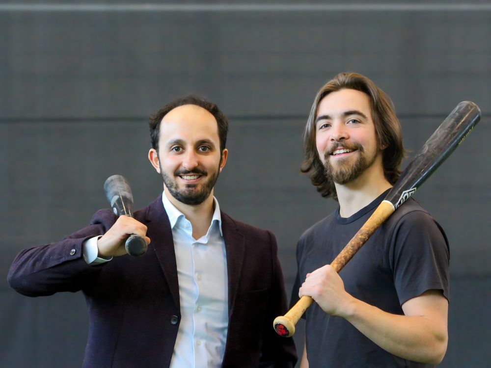 Joshua Pope (BASc ’19) and Rowan Ferrabee (BASc ’19) holding up baseball bats over their shoulders