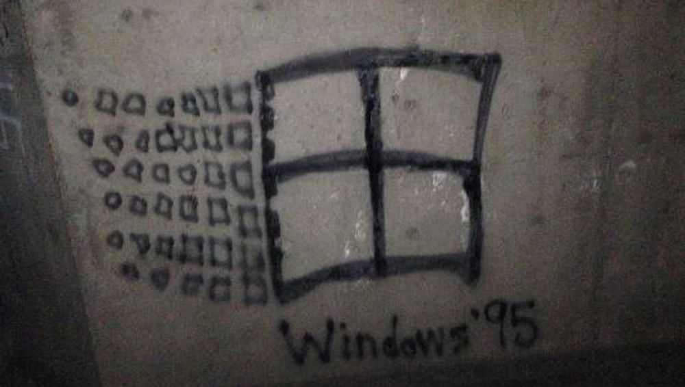 A spray painted Windows 95 logo that was previously a swastika