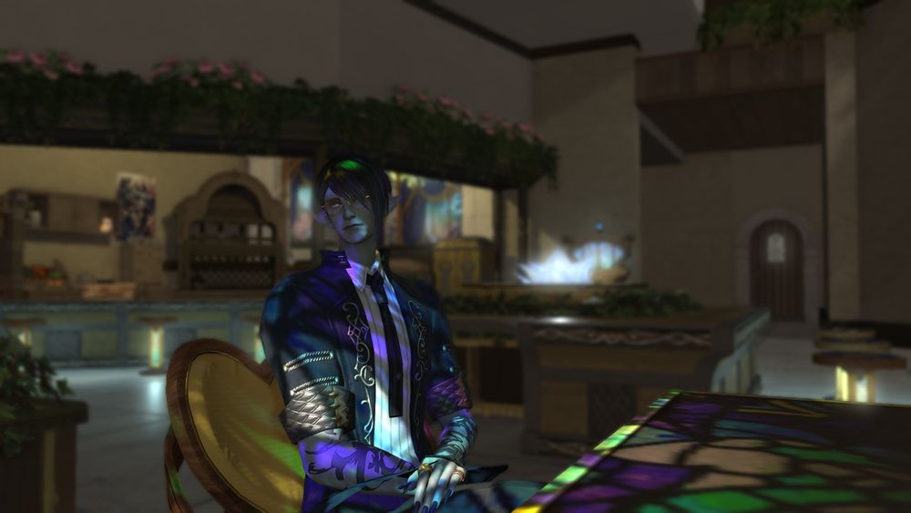 Felix sitting in Crossroads with the light from the stained glass windows washing over him.