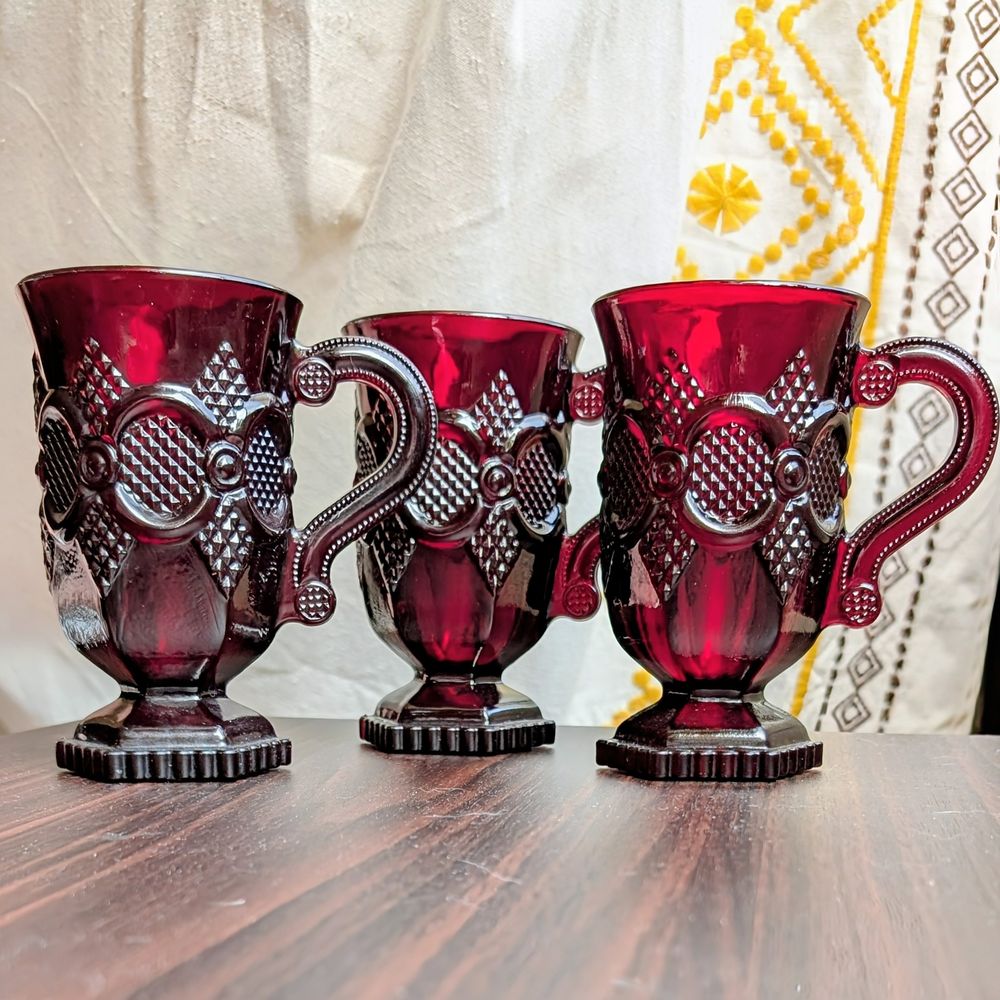 Brilliant ruby red glass thin coffee mugs with embellished vintage reliefs of diamond texture and raised circular frames