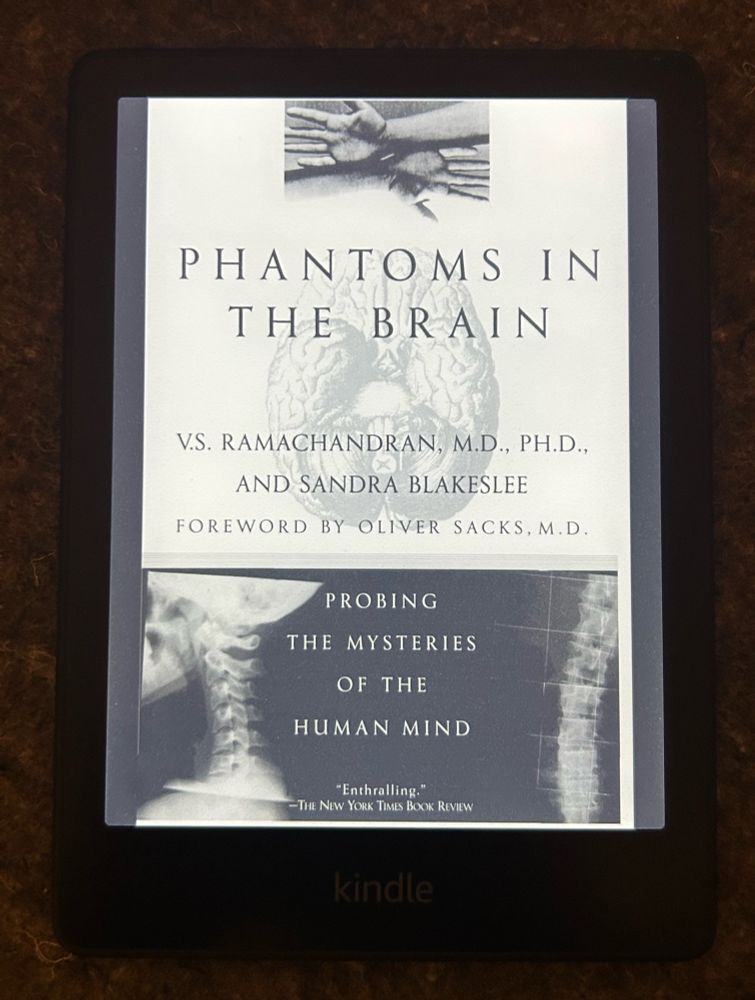 A kindle displaying the front cover of “Phantoms in the Brain” by V. S. Ramachandran. 
