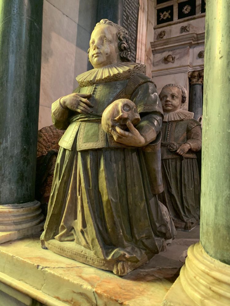 Two sculpted figures of young boys [deceased] holding skulls. Located on the tomb of Francis Manners, 6th Earl of Rutland, in the Bottesford church.