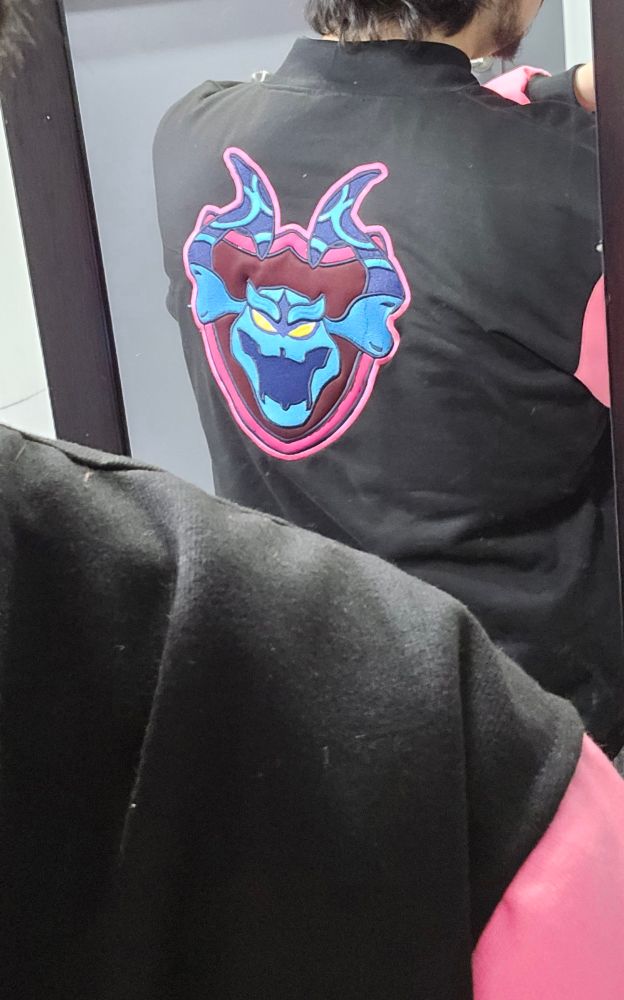 Picture of me wearing the jacket, with a patch on the back depicting the Storm King, the final boss of Fortnite Save the World
