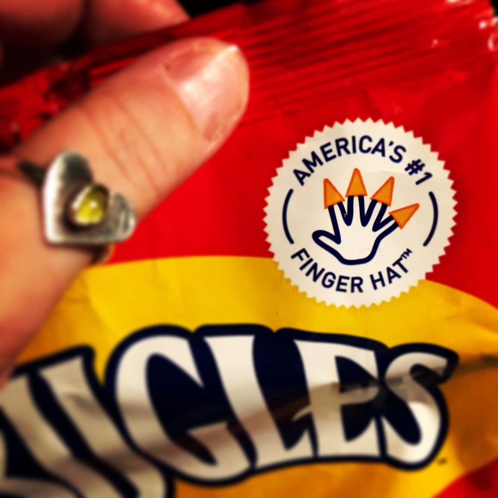 Closeup of a bag of Bugles which has AMERICA’S #1 FINGER HAT in the top right corner of the bag design. 