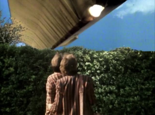 Arthur Dent and Ford Prefect looking at the arriving Vogon construction fleet, who have arrived to blow up the Earth.