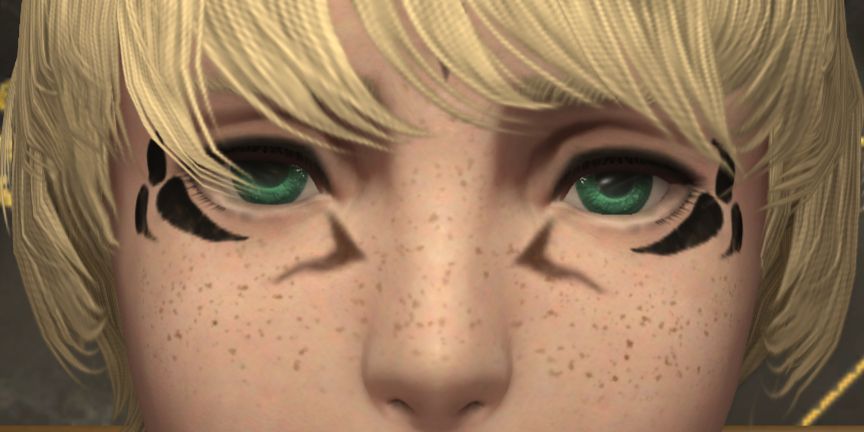 A close up on Jariq'a's eyes and their natural green color.