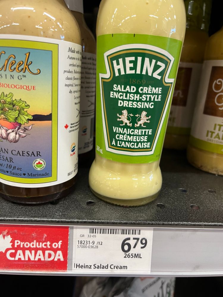 A bottle of Heinz salad cream, Which is made in the US, above a price sticker and a made in Canada sign.  