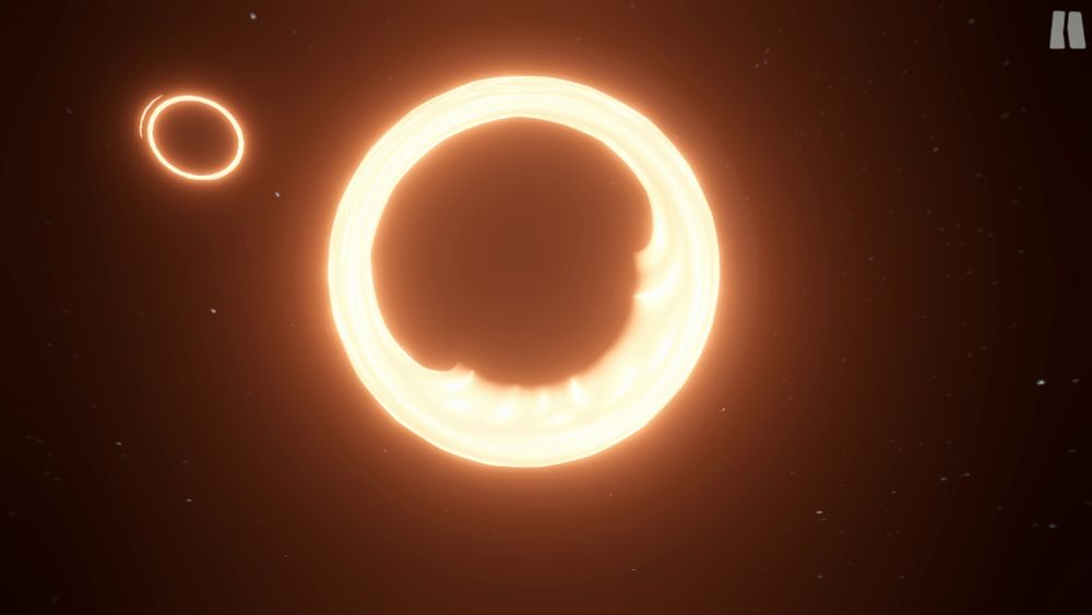 Screenshot of Cosmic Crescendo Gameplay:
Two black holes in space with their brightly glowing, orange rings. The one in the center being much larger than the one to the left.