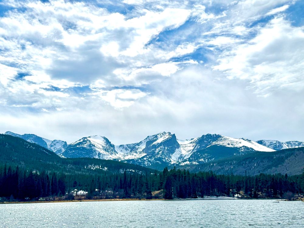 Snow covered mountains with a lake in front.