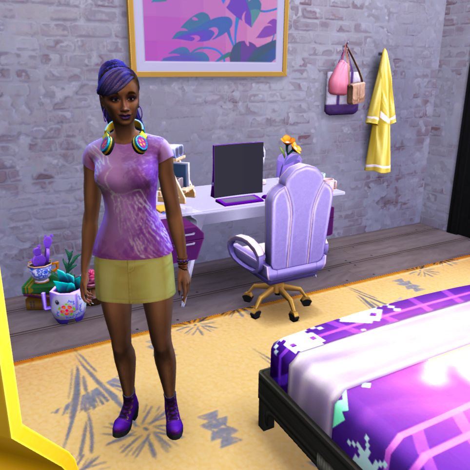 Ainsley Aquarius is an Aquarius-themed Sim created in the Sims 4. She is standing in her bedroom, decorated with a purple and yellow theme. Beside her is the corner of her bed, with a cover decorated with 80s computer game graphics. Behind her is her purple computer on her desk and some general clutter. My colour themes are related to the colour coding I give the different zodiac signs. Black is for Cardinal Signs, Purple is for Fixed Signs, and Orange is for Mutable signs. Green is for Earth signs, Blue is for Water signs, Red is for Fire signs, and Yellow is for Air Signs. Aquarius is Fixed Air, so her theme is purple and yellow. 