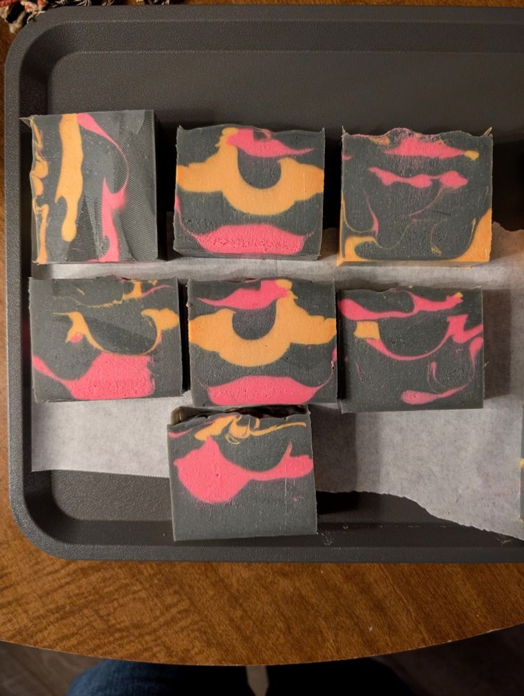 Slices of the forbidden cake (soap). It's grey with bright pink and orange 