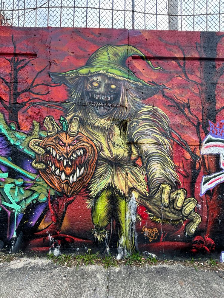 A large evil scarecrow holding a pumpkin mural on the south side of Chicago.