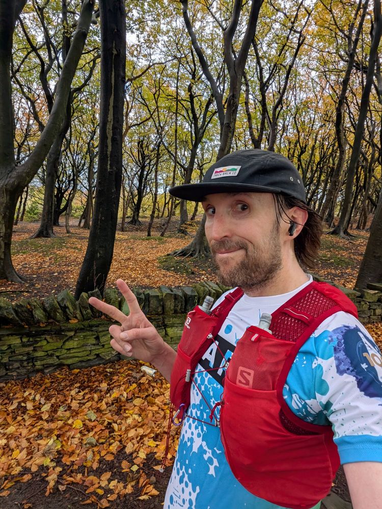 Myself mid run smiling and peace sign to camera 