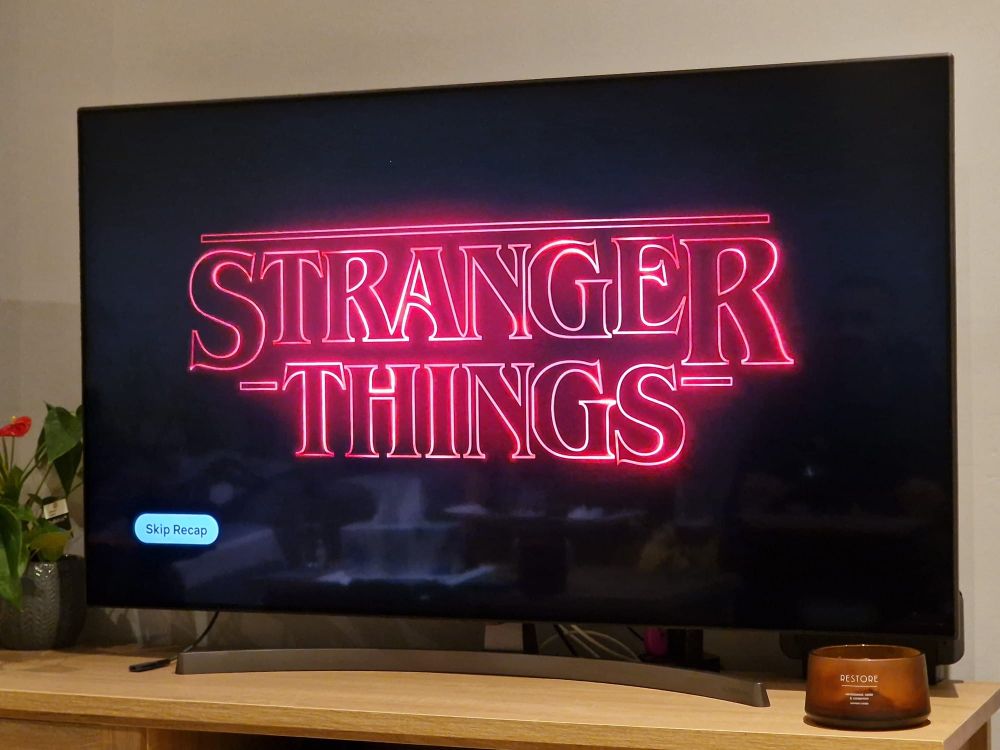 A TV screen showing the title Stranger Things.