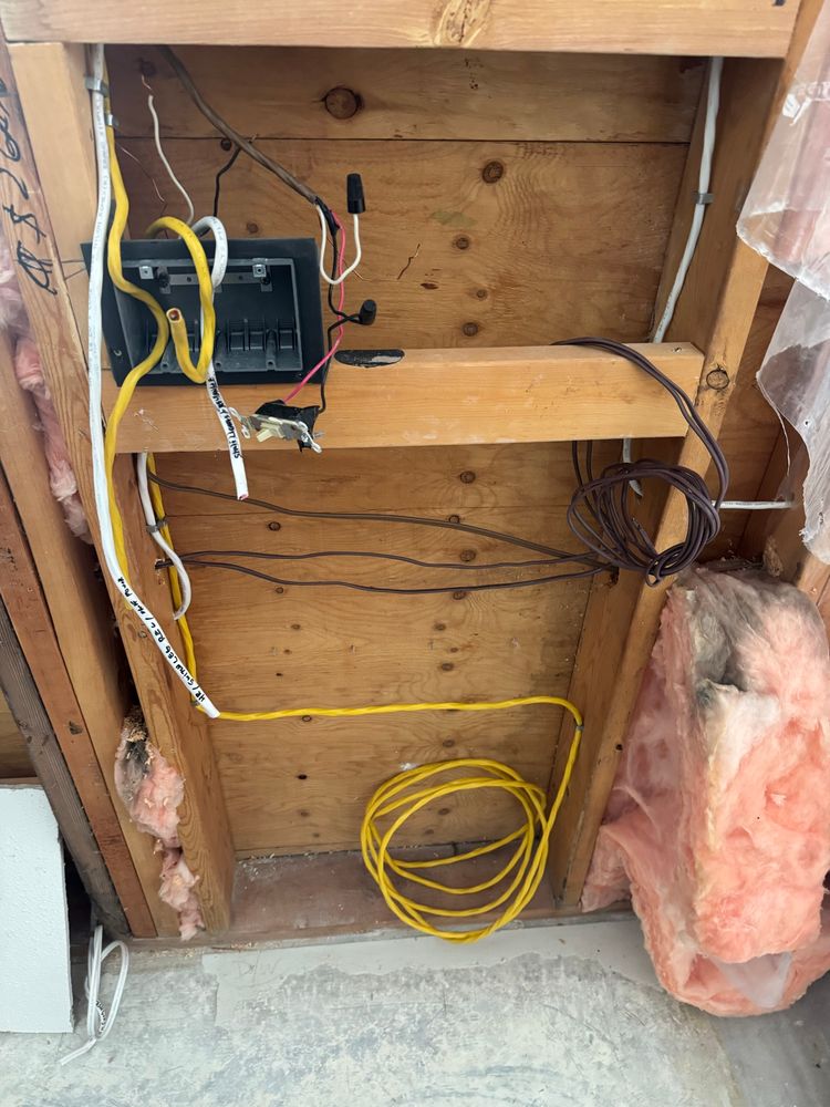 electrical box and yellow wire in an open wall