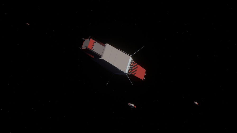 A 3D render of a boxy red and grey spaceship. 3 more ships can be seen behind it.