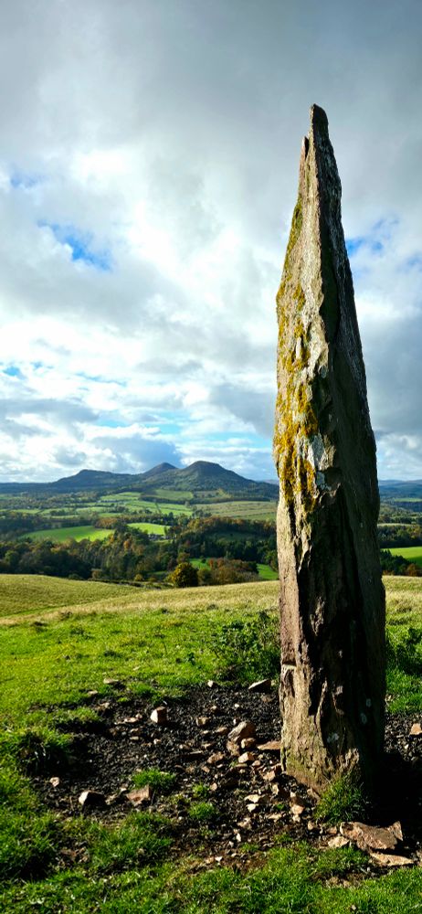 Bemersyde Hill standing stone with the Eildon Hills in the distance.