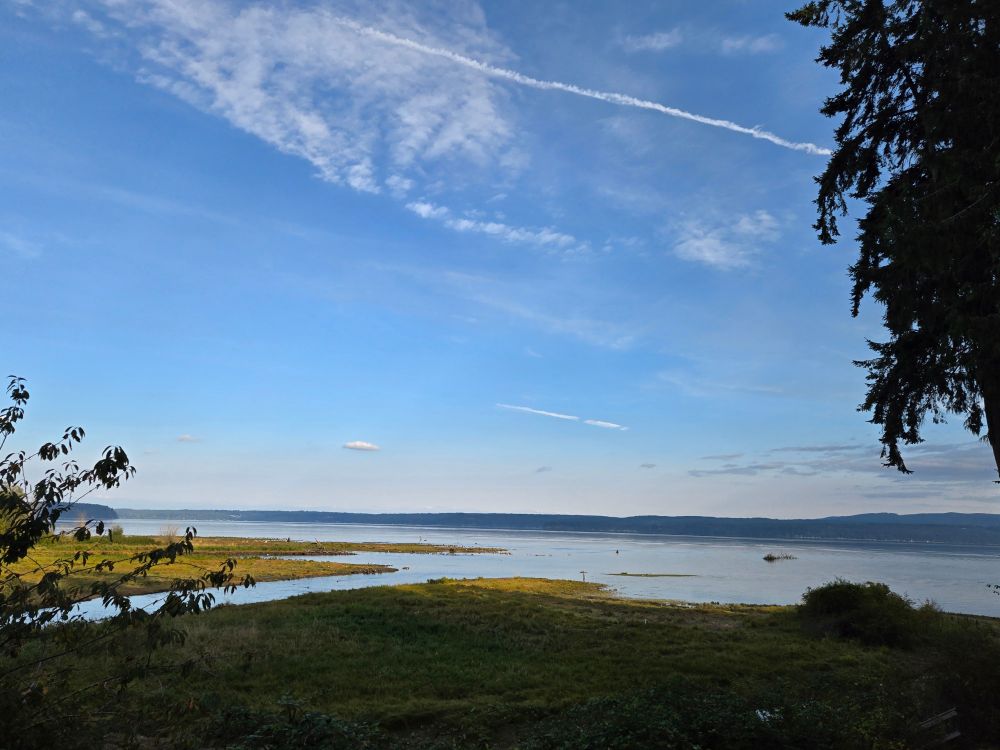 Image of the late summer sky over the Hood Canal in Washington state's Olympic peninsula.  You can see fingers of water reaching to the shore, filled with salmon on their last fall run, and hundreds of seals who think it's their private buffet. 