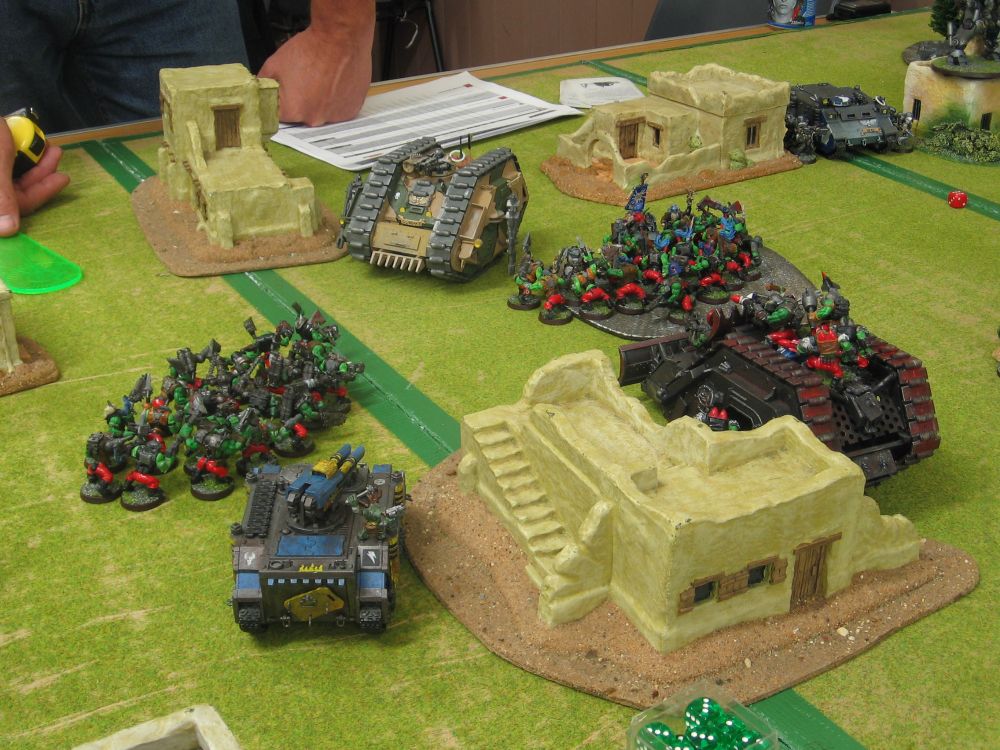Two huge mobs of Orks charge towards Grey Knight lines.