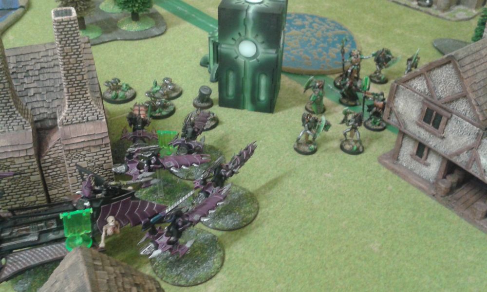 Five Dark Eldar jetbikes and a Raider prepare to charge Necrons lychguard and lord.