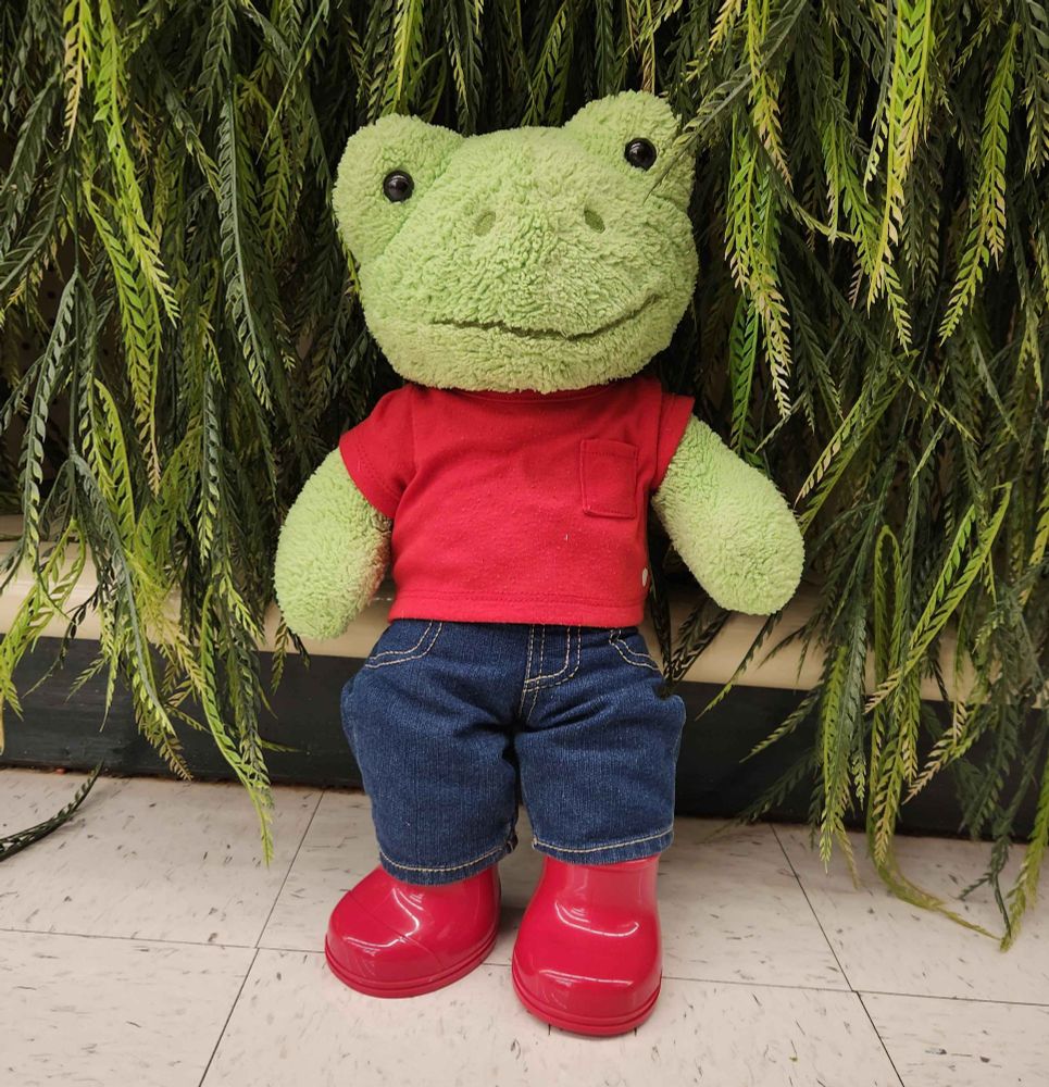 Green build-a-bear frog wearing a red t-shirt, denim jeans and red rubber boots