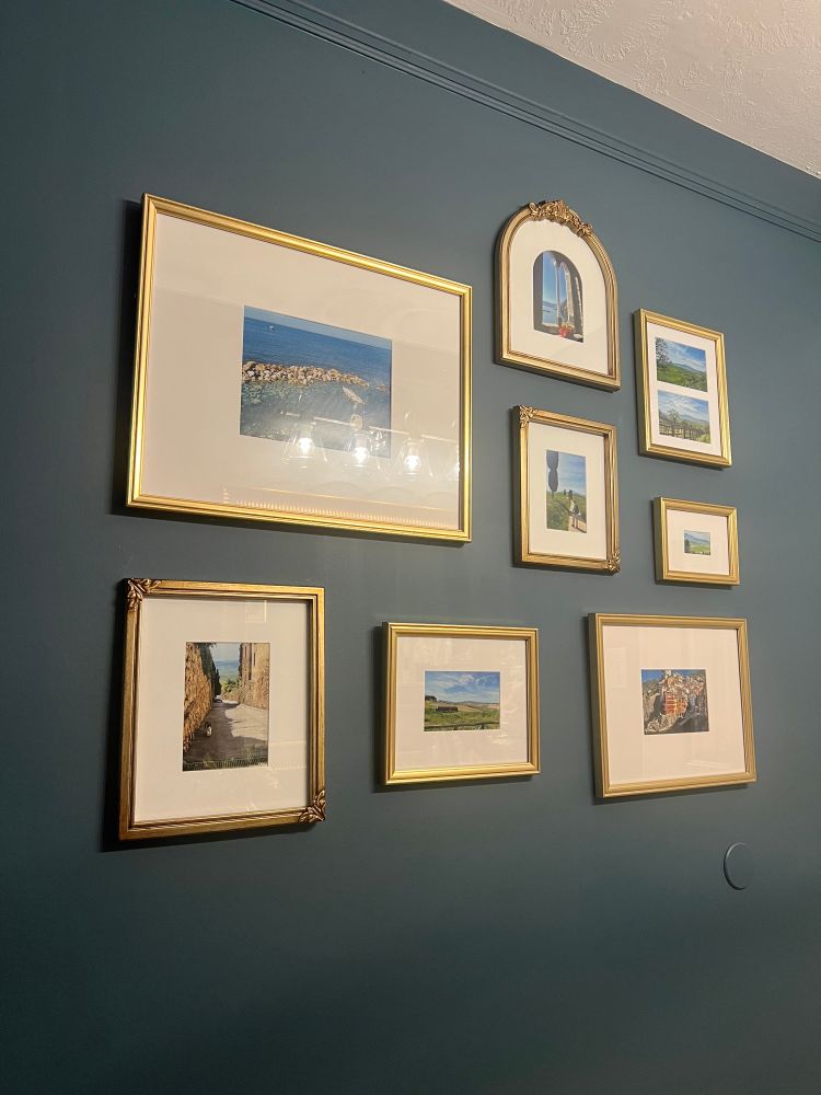 Teal wall in my powder room with a gallery of photos from our last trip to Italy. 