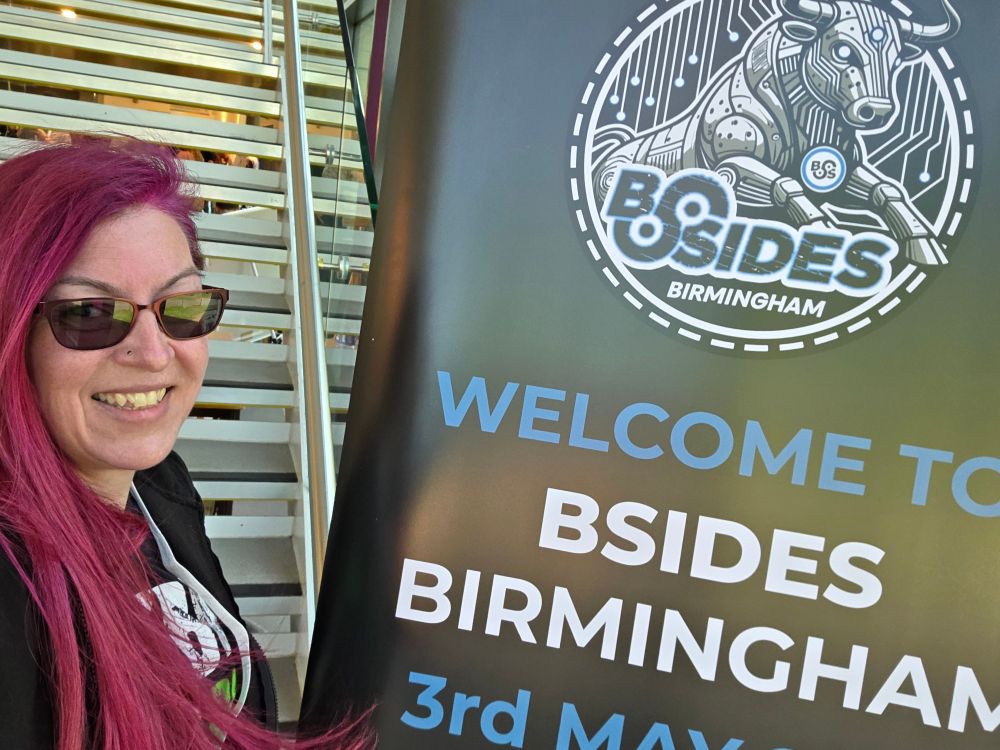 Me in front of BSides Birmingham banner.