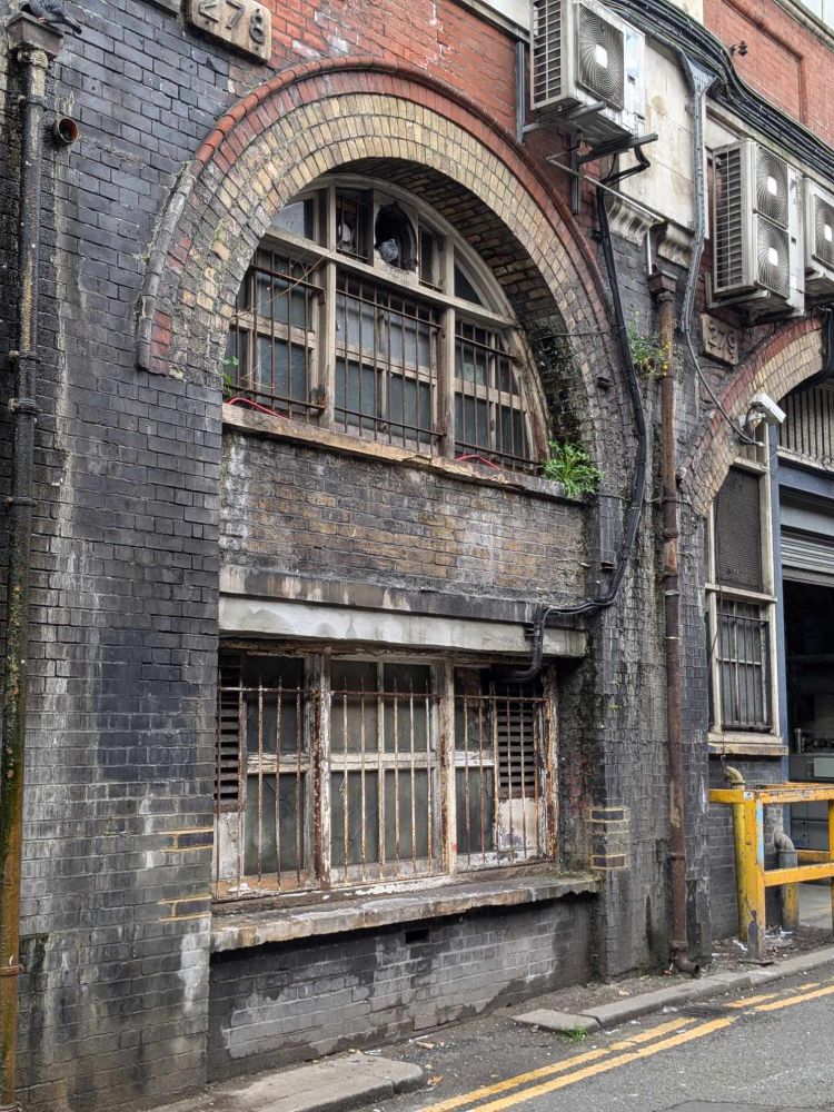 A heavily weathered wall with windows near Waterloo Station in London