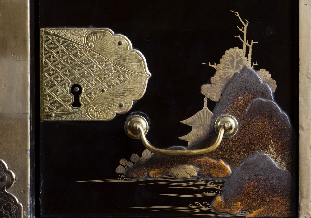 Lock escutcheon and handle on the Japanese lacquer cabinet on a Dutch gilt stand, c1630-50, in the Long Gallery at Ham House, Richmond-upon-Thames. ©National Trust Images/John Hammond 