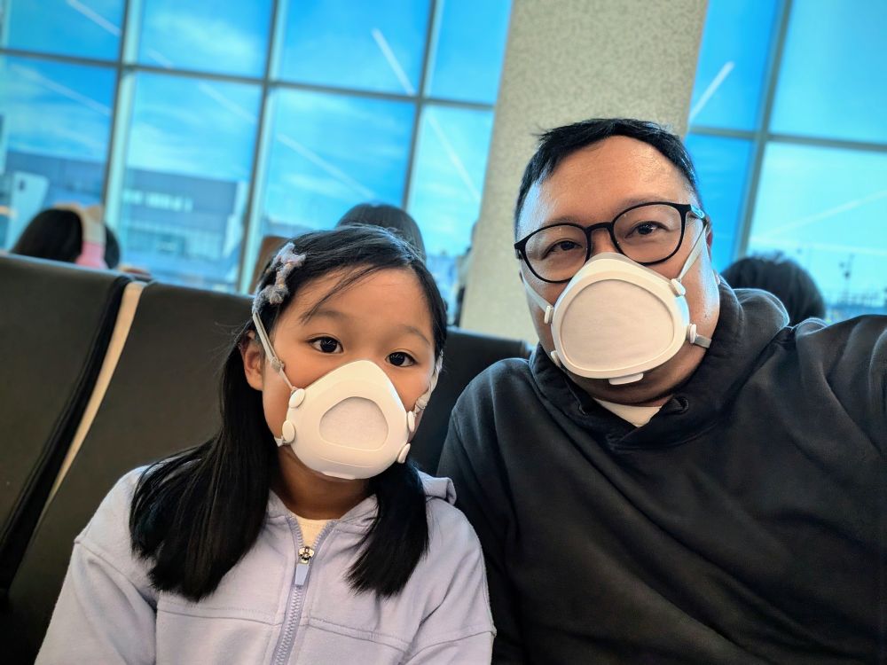 Dad and daughter both wearing Flo Mask at the airport.