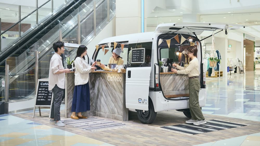 promo picture of a honda N-Van E:L4 set up as a coffee shop inside a shopping mall concourse for some reason