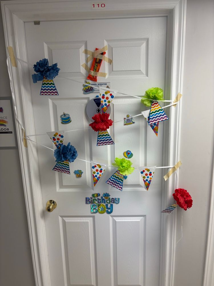 A door covered in birthday decorations. 