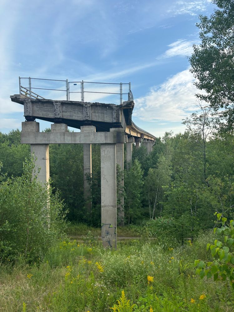 Abandoned highway bridge photo taken from the end of the bridge. 