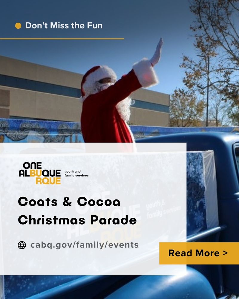 Santa Claus waves from a vehicle.