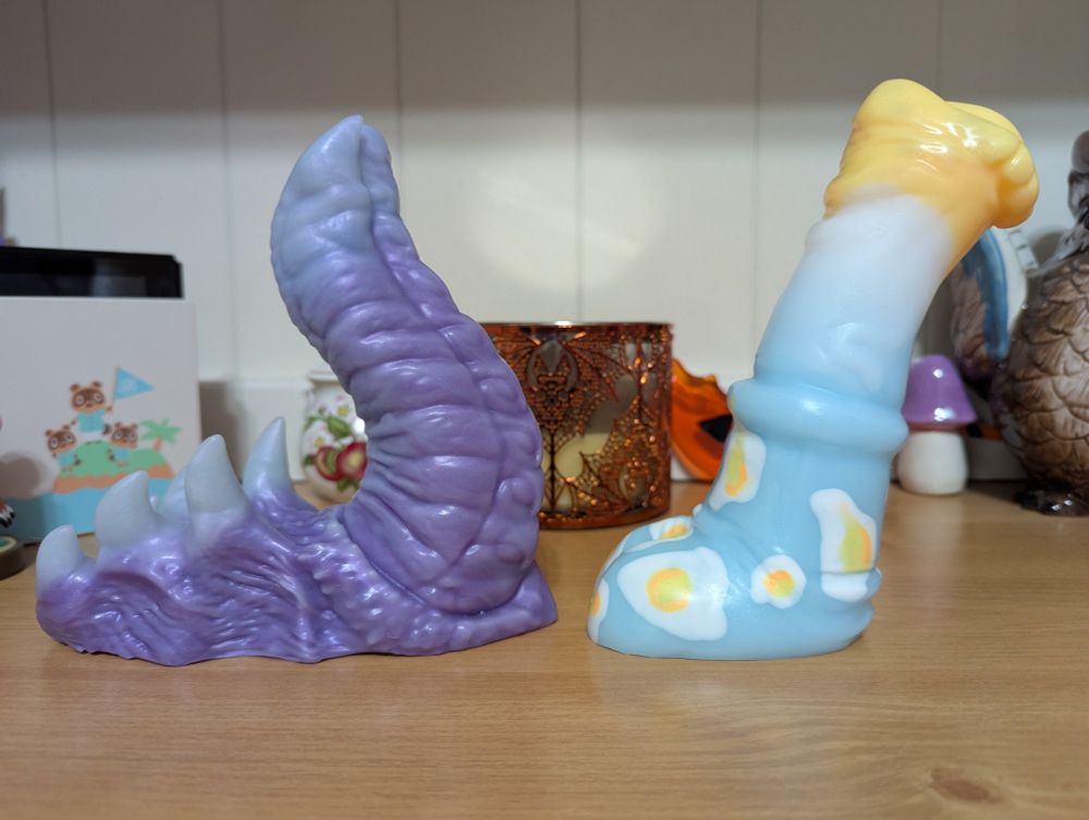 A purple and white Imago from Xenocat Artifacts and a Kose from Creature Feature Toys in white, yellow, and blue with painted on eggs.