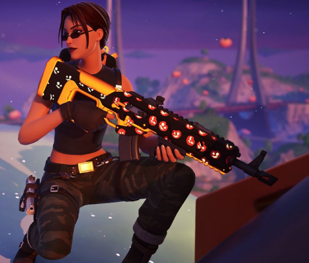 Lara Croft holding an assault rifle decorated with Jack-O-Lanterns.