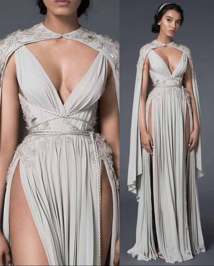 Two photographs of a model wearing a dress from the Paolo Sebastian ‘Persephone’ Spring 2021 Haute Couture Collection. The dress looks vaguely grecian or roman, with grey fabric that has lots of pleats that go down to the floor. The top of the dress has a deep V that goes down to below the breasts and is tied with a pale grey corded rope under the breasts and around the waistline. The dress has high slits that go up to the hips on either side of the long skirt. The dress has a matching cape that is fastened around the neck and lays over the shoulders and cuts back behind the arms, falling into pleats to around knee-length.