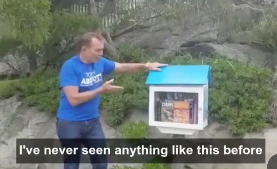 Photo of Tony Abbott discovering a little free library in the wild. He says "I've never seen anything like this before"