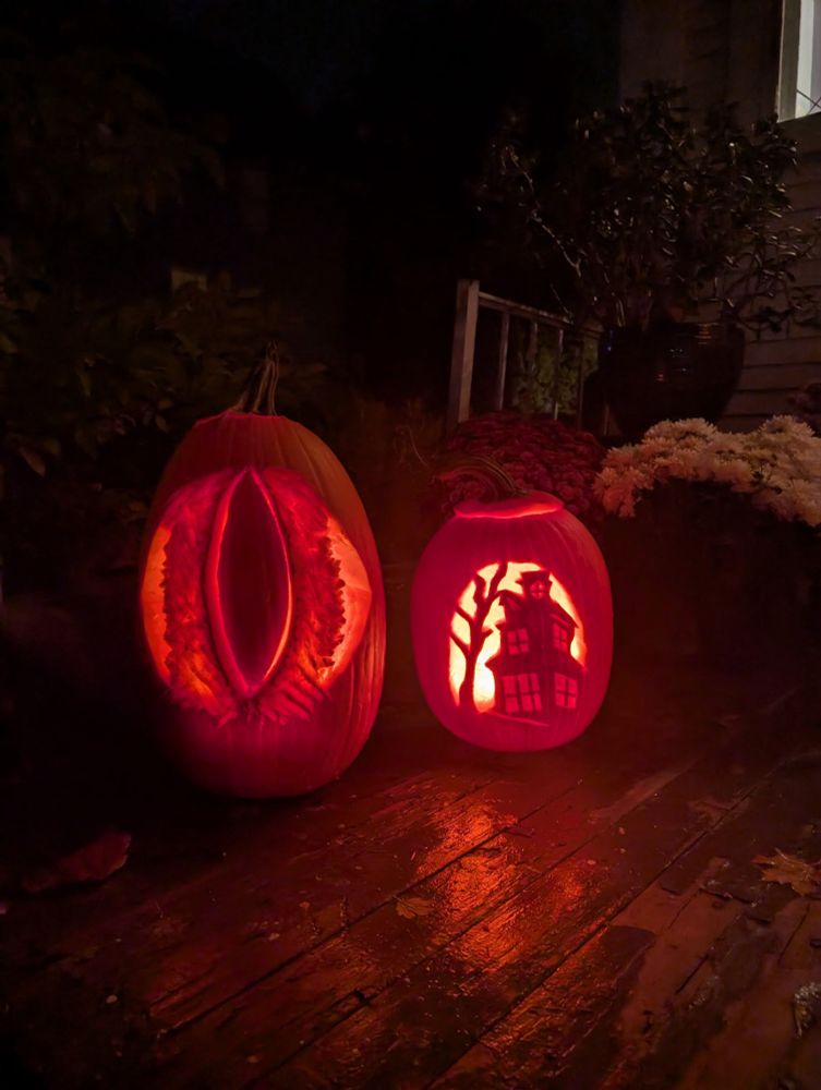 Two jack-o-lanterns: one vaguely anatomical looking, and the other with a spooky tree and haunted house 