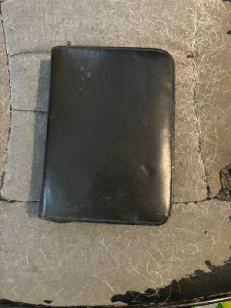 A small black leatherette case