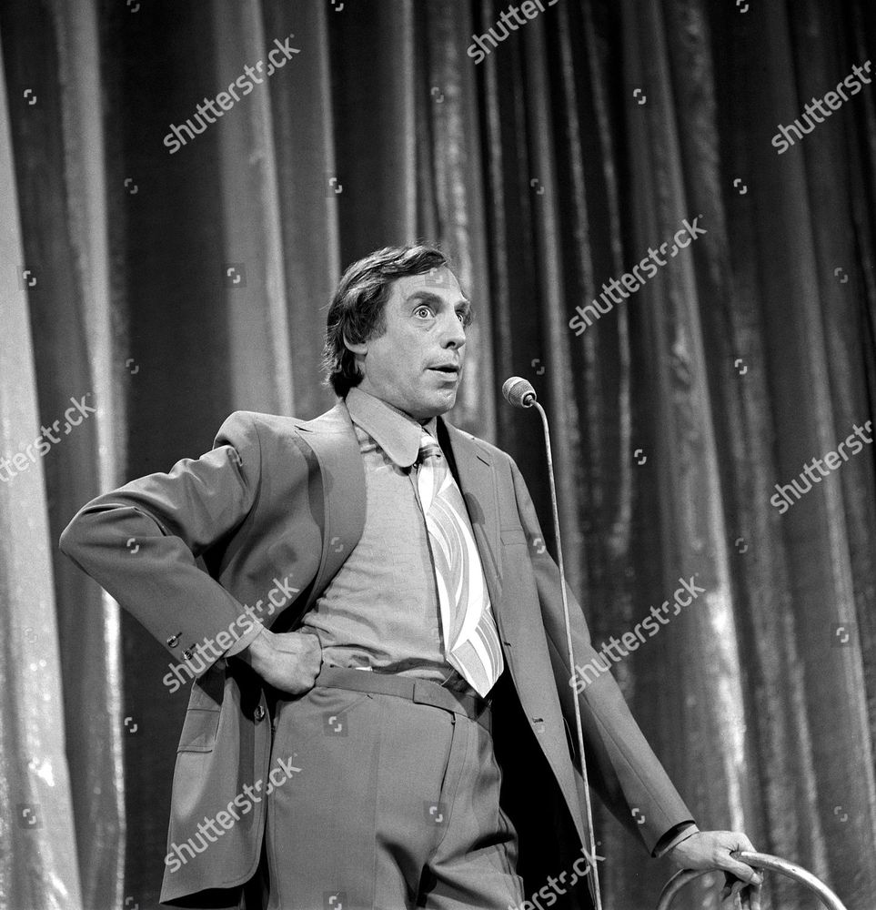 photo of old comedian Larry Grayson on stage, looking rather camp