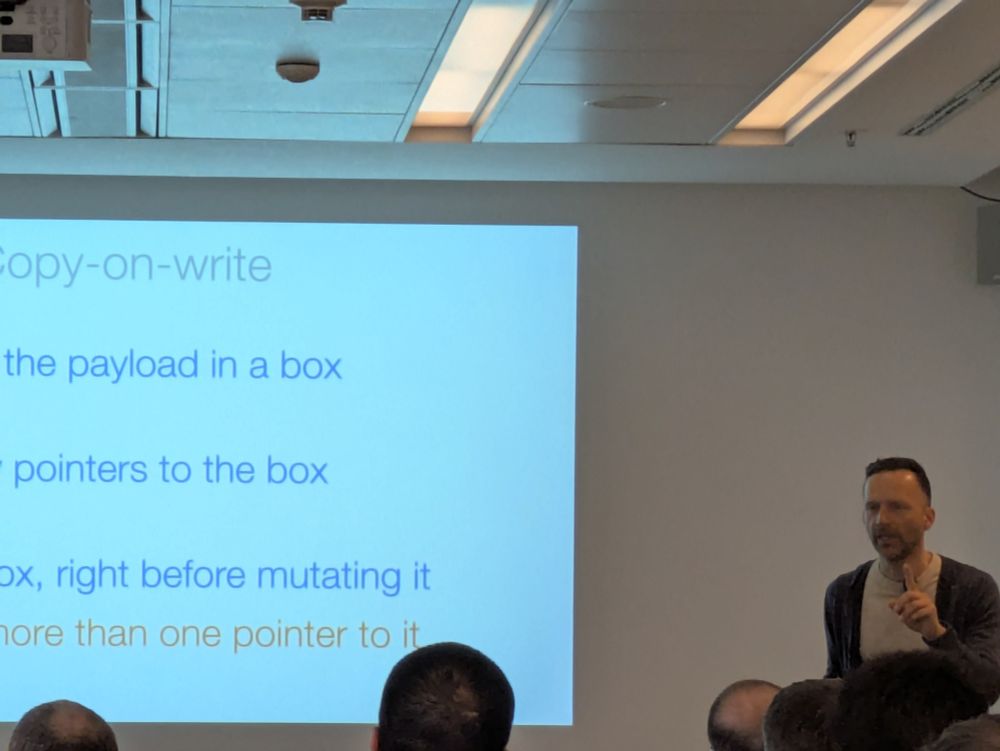 A person giving a talk at a conference.