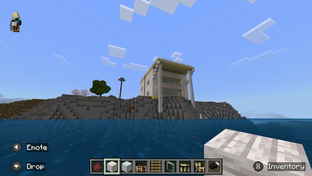 The finished house, with large windows facing the sea. The flat roof extends out, supported by columns, to shade the large windows from high angle summer sun