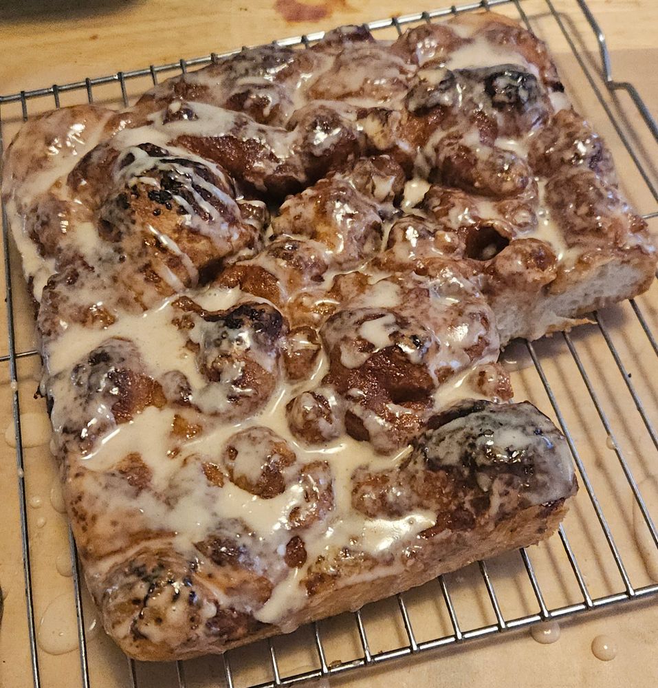 Cinnamon and sugar foccacia with a powder sugar glaze; a piece is missing. 