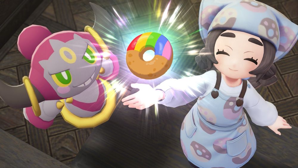 Hoopa and Ansha holding up a Rainbow Donut in Pokemon Legends: Z-A (Mega Dimensions DLC)