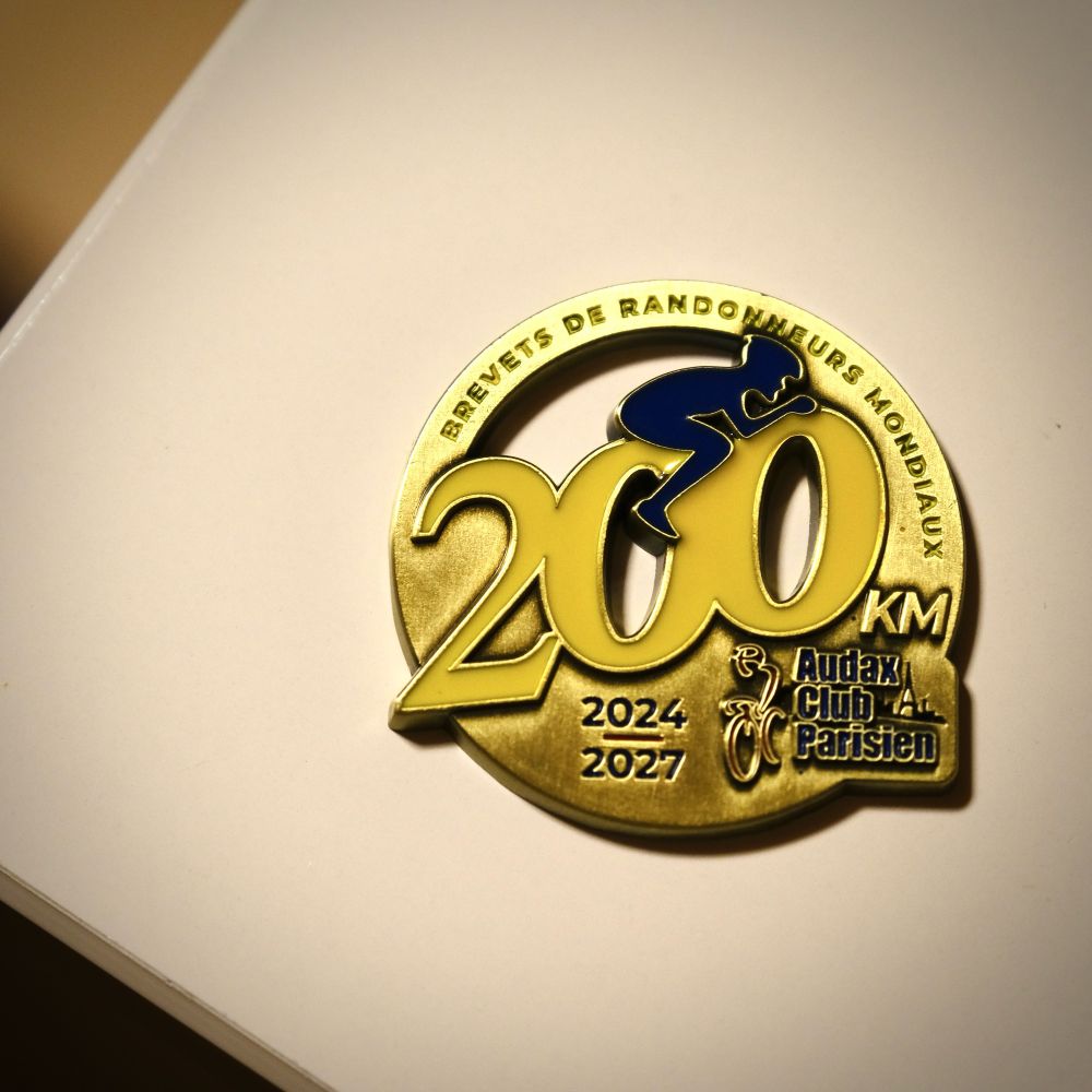 Audax Club Parisien 2024-2027 200 km brevet medal on white table
